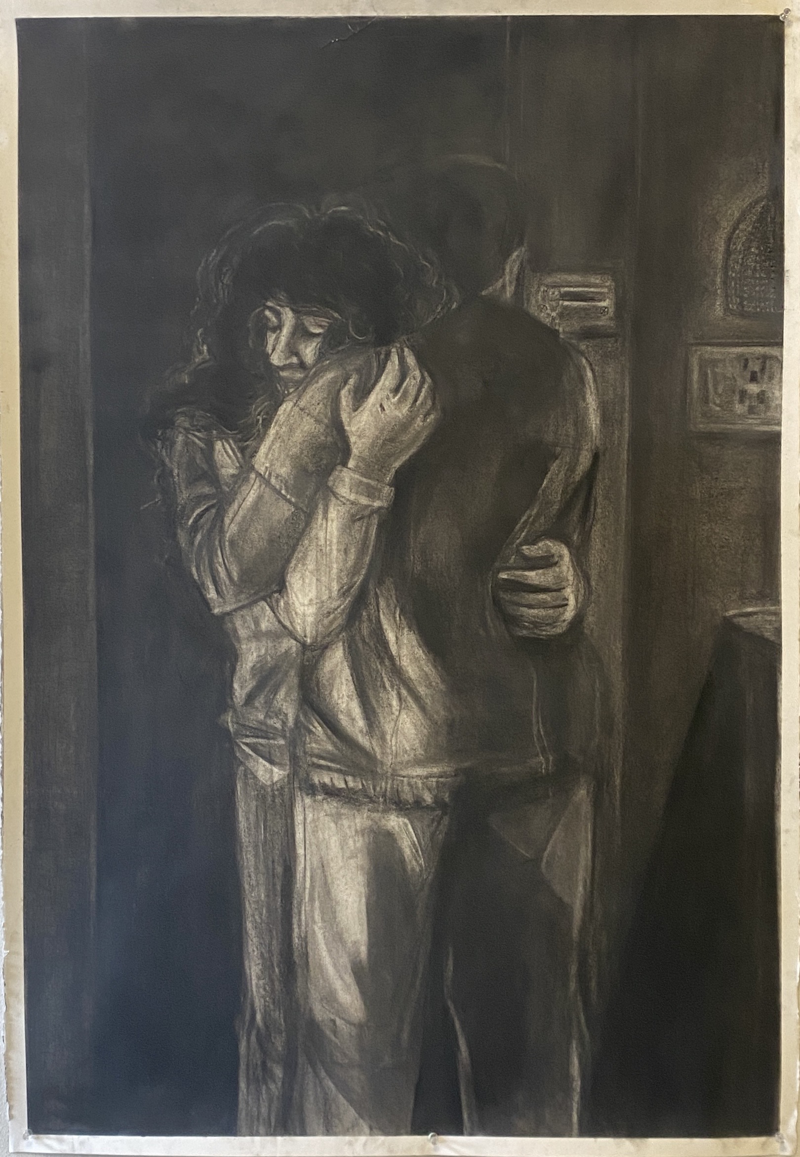 Image ID: A grainy charcoal drawing of two women embracing, one of whom is taller and has her back to the viewer. They are situated in an interior besides a door.