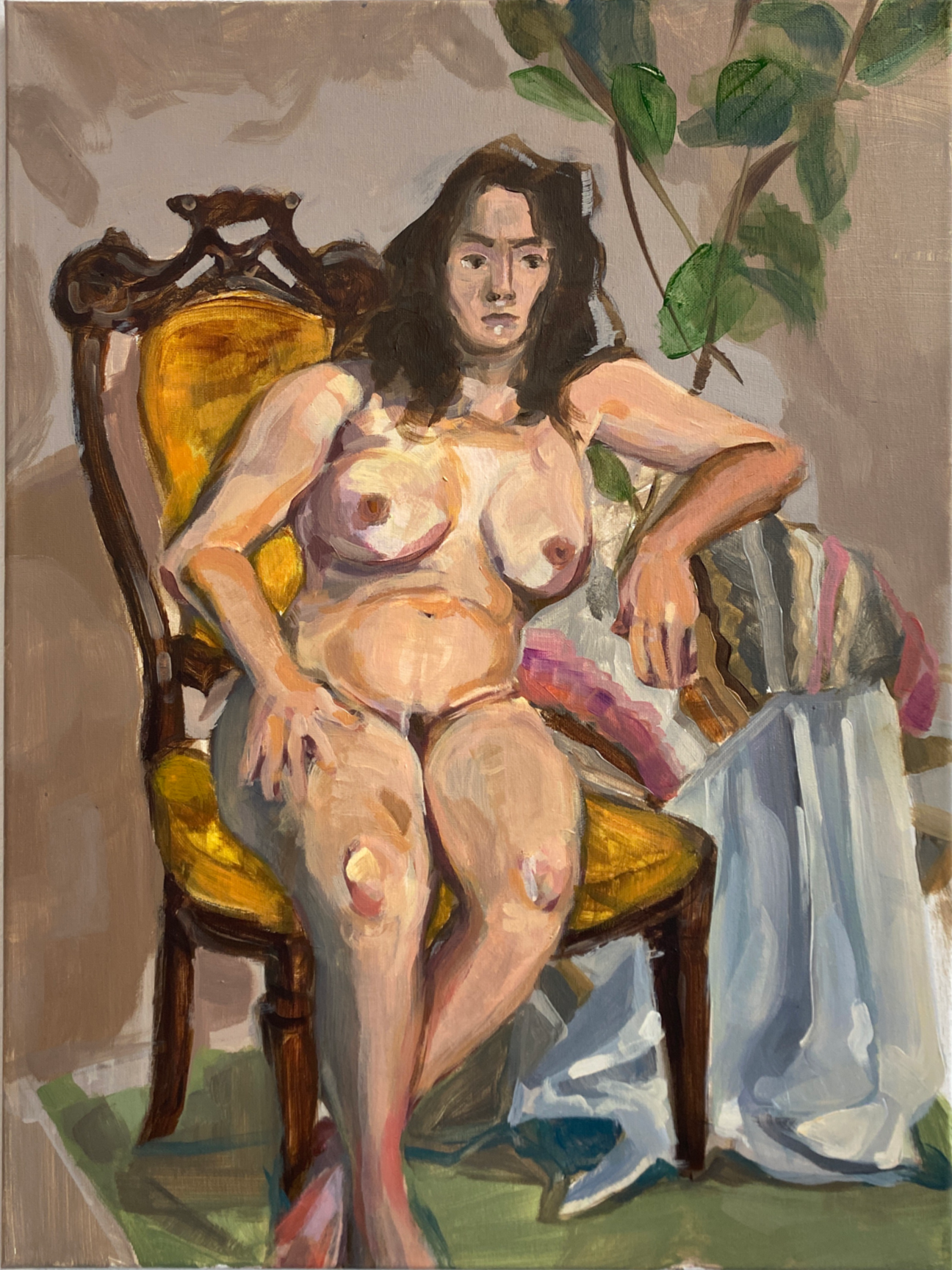 Image ID: A gestural painting of a nude, fair-skinned woman with brown hair and eyes on a somewhat plush yellow chair. The model is leaning on a table with a draped blanket over it and tall plant behind it.